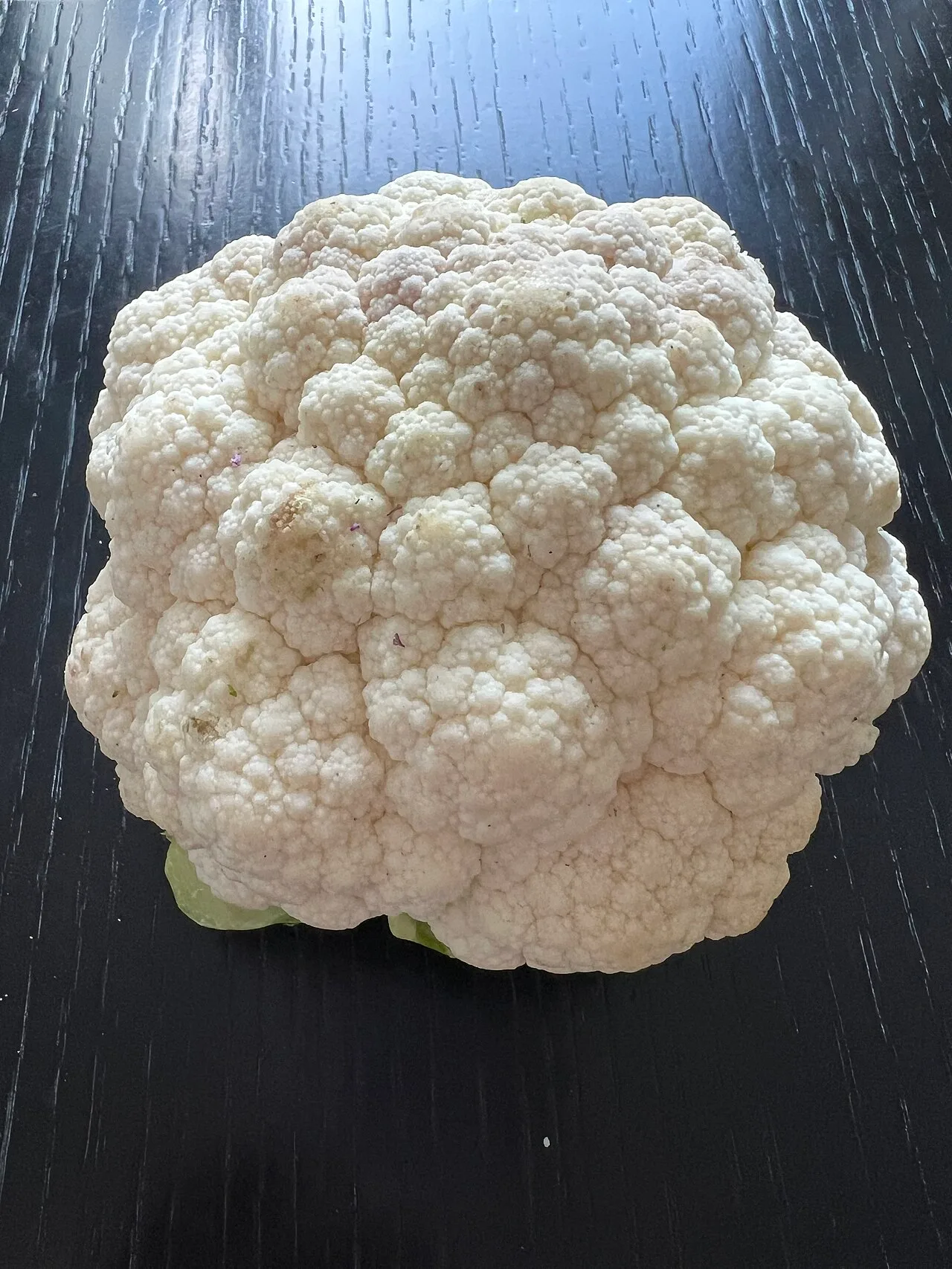 Fresh whole cauliflower head with dense white florets