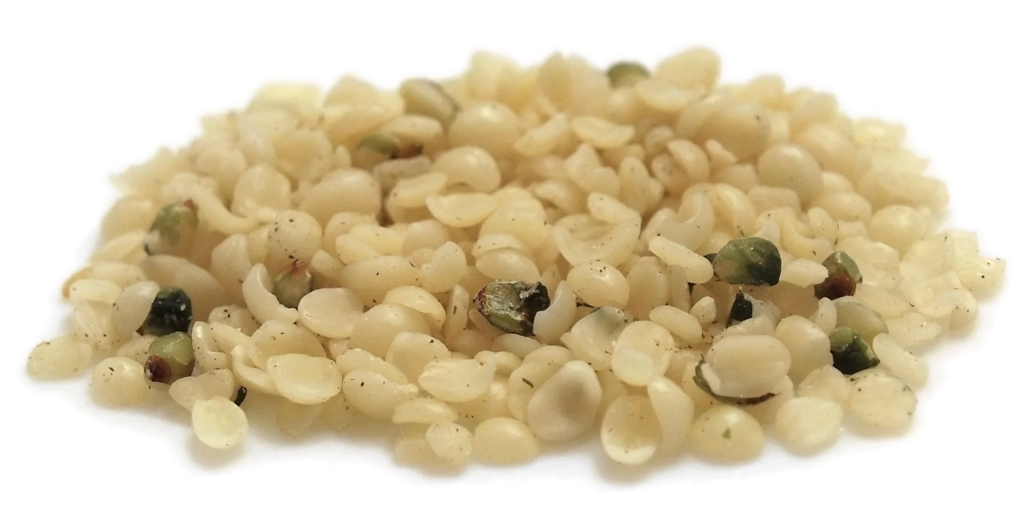 Hulled hemp seed kernels on a white background